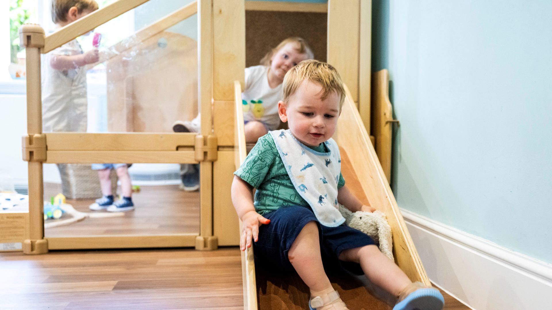 toddle going down a slide